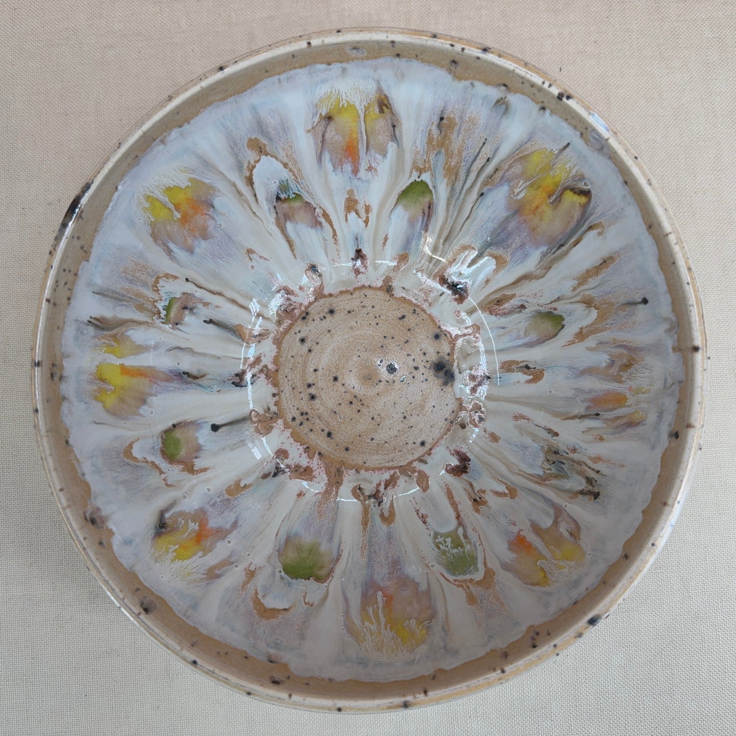 Decorative ceramic bowl with floral patterns on a beige background
