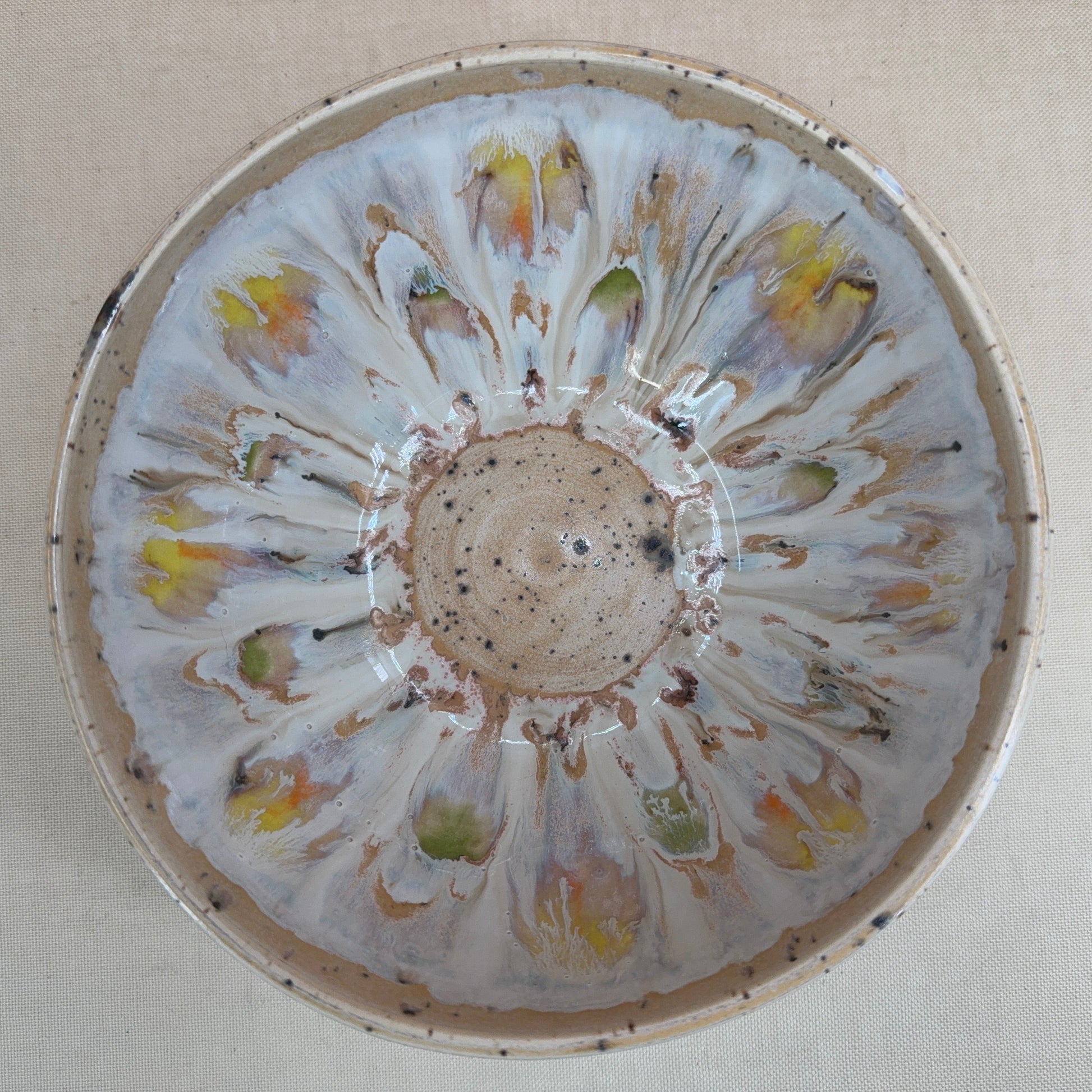 Decorative ceramic bowl with floral patterns on a beige background