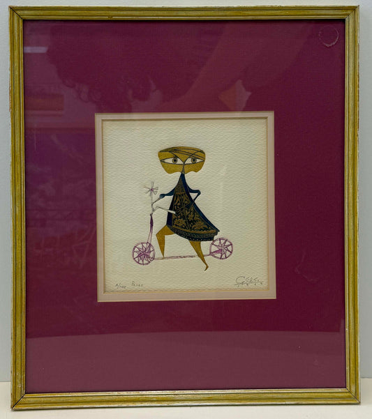 Framed artwork titled "Paseo (1612), A/100" featuring a stylized figure with large yellow eyes riding a bicycle with pink wheels, displayed against a white background and maroon mat in a gold frame. The framed dimensions are 13.5 x 16.5 inches.