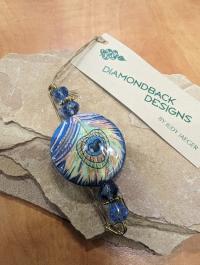 Ceramic round blue peacock feather Pin by Judy Jaeger
